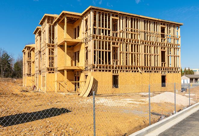 construction zone secured with a temporary fence, marked with warning signs in Sahuarita, AZ